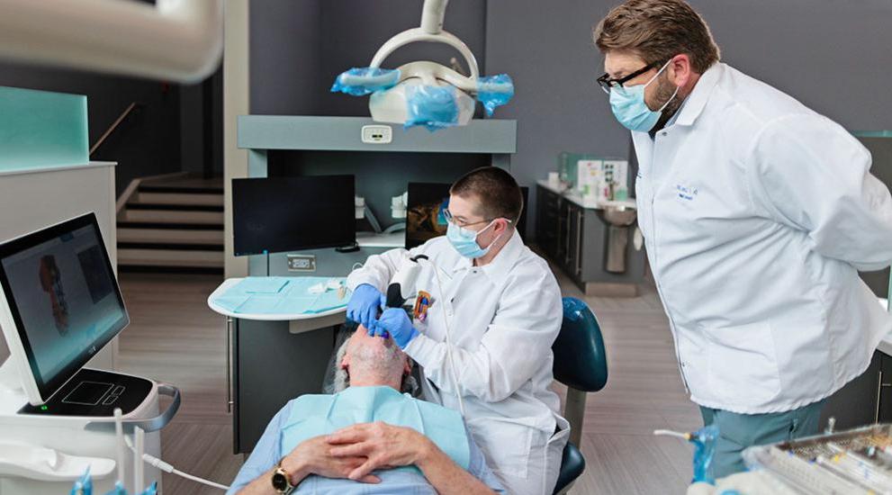 Dental student being helped by professor